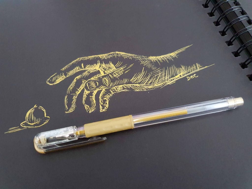 A drawing oa a hand reaching for a nut in gold pen on black paper