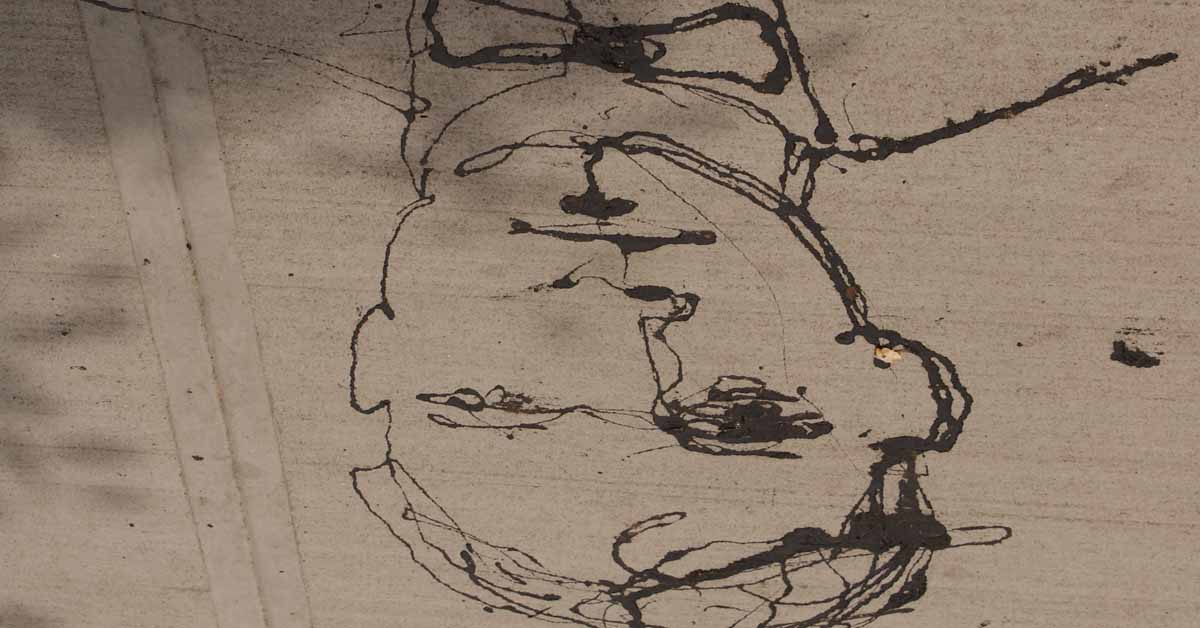 An upside down drawing of a mans face in black ink