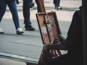 An artist painting on an easel