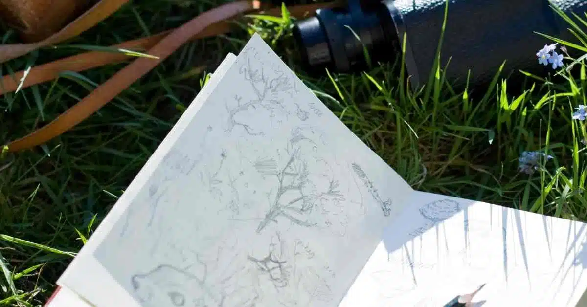 Travel sketchbook on grass