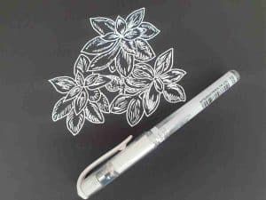 Drawing a plant on black with white gel pen